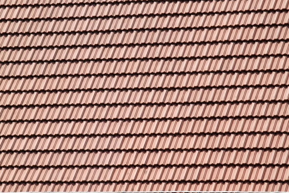 Professional roofer installing shingles on a residential roof