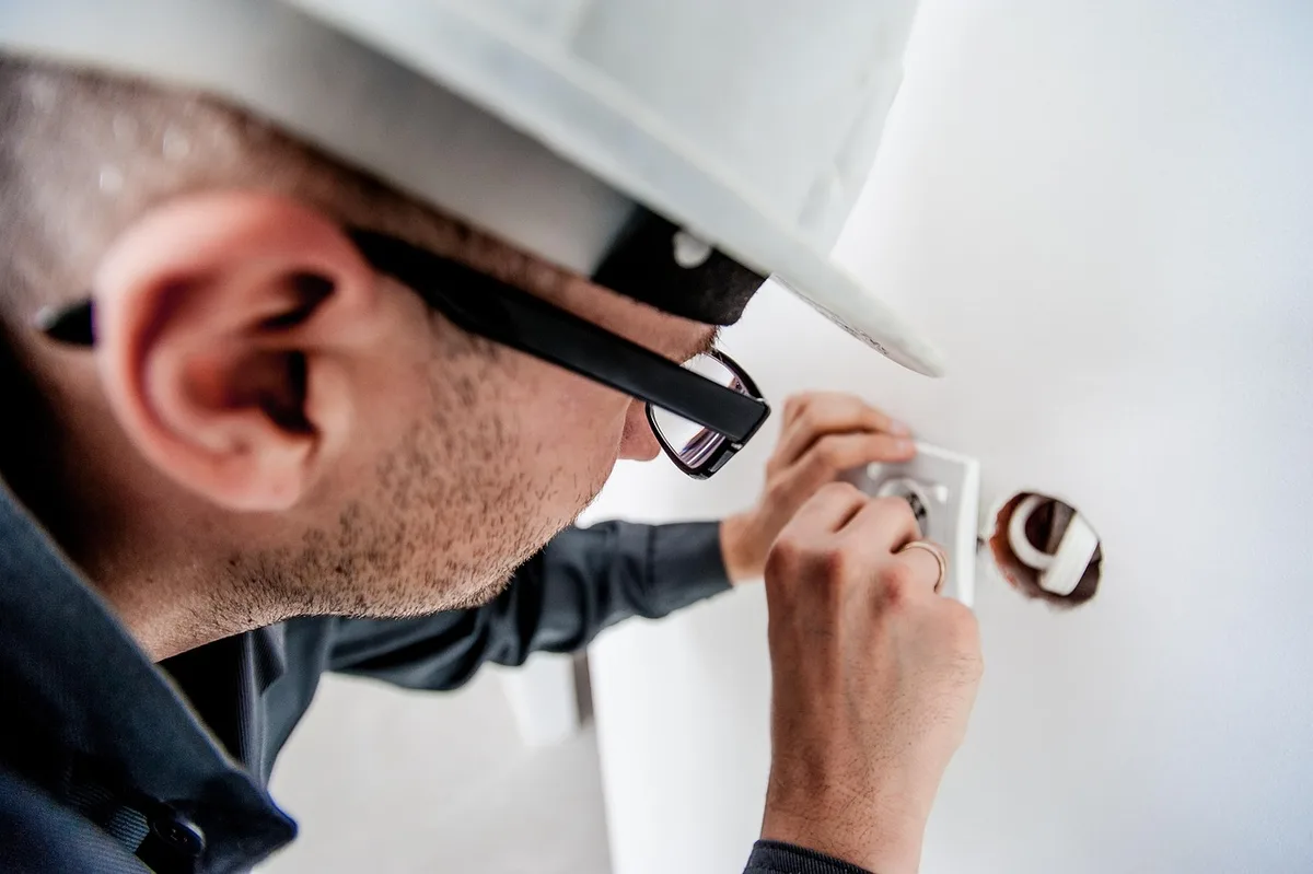 Licensed electrician working on a residential electrical panel