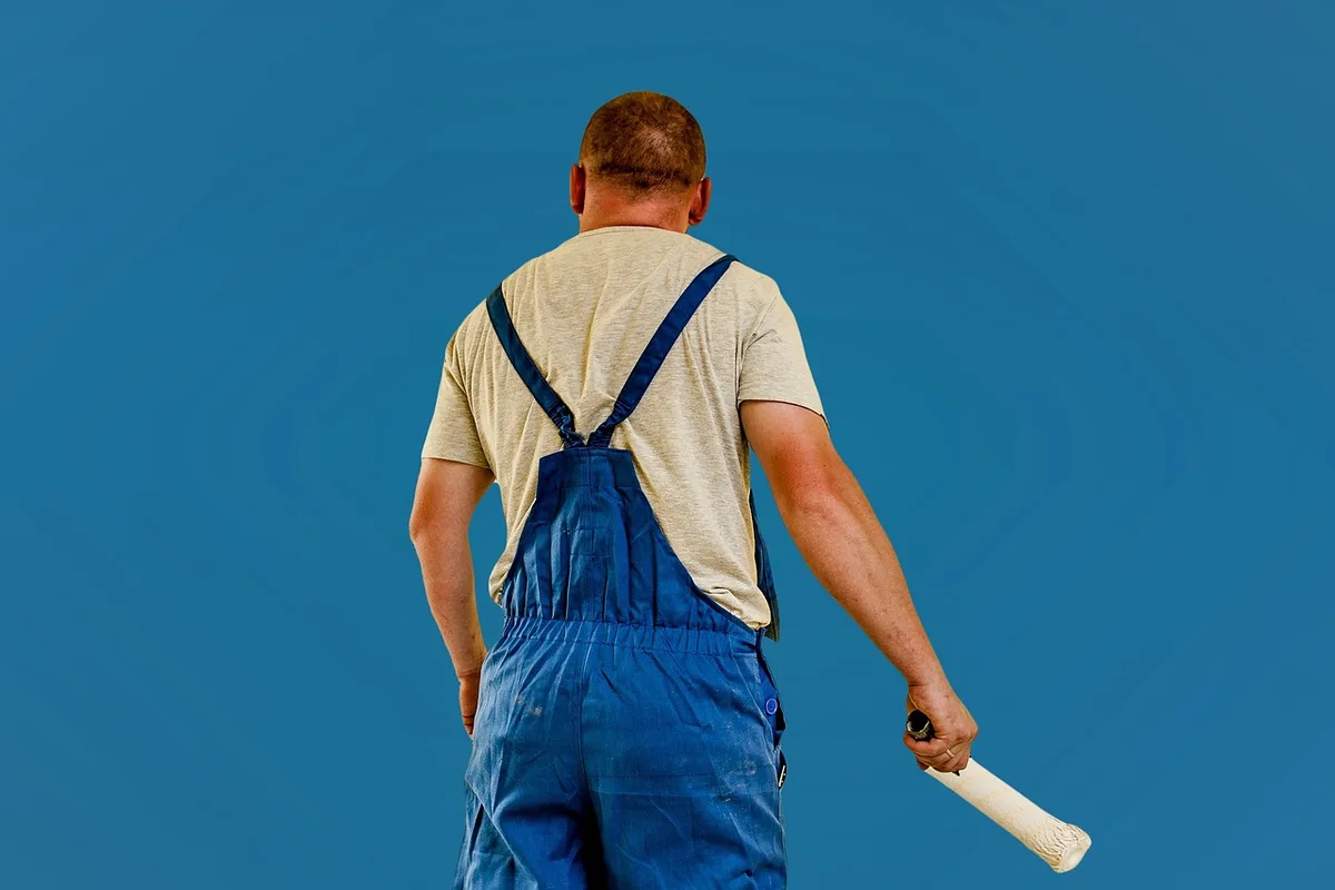 Professional painter painting the exterior of a house